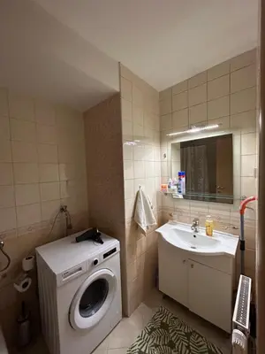 a bathroom with a washing machine and a sink at Vert Apartment in Banja Luka