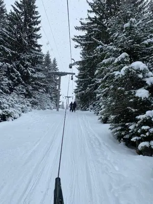 a group of people on a ski lift in the snow at Apartman SkiBeg, Vlašić in Vlasic