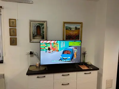 a flat screen tv sitting on top of a dresser at Apartman SkiBeg, Vlašić in Vlasic