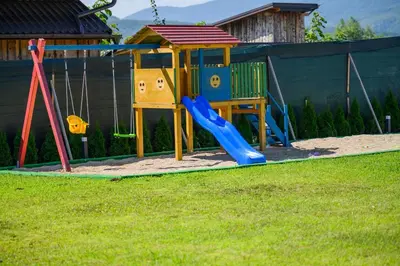 a playground with a slide in a yard at Summer Residence Una in Bihać