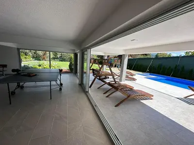 a room with a pool table and chairs on a patio at Summer Residence Una in Bihać