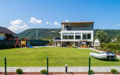a house with a large yard with a playground at Summer Residence Una in Bihać