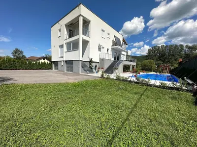 a large white house with a yard and a swimming pool at Summer Residence Una in Bihać