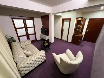 a living room with couches and chairs and a television at Hotel Laktaši in Laktaši