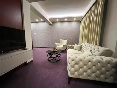 a living room with a couch and a flat screen tv at Hotel Laktaši in Laktaši