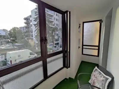 a room with a window with a chair and a table at Apartment Alex in Banja Luka