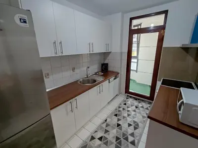 a kitchen with white cabinets and a sink at Apartment Alex in Banja Luka