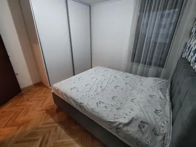 a small bedroom with a bed and a window at Apartment Alex in Banja Luka