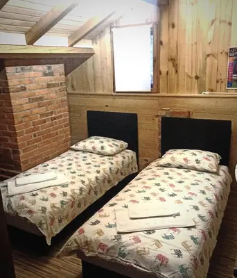 two beds sitting next to each other in a room at Villa FORESTA in Banja Luka