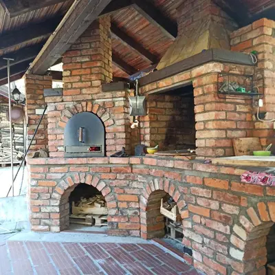 a brick oven with a pizza inside of it at Villa FORESTA in Banja Luka