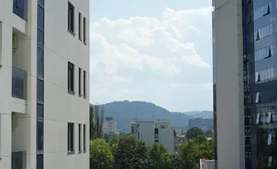 a view of a city from between two buildings at GRAND LUX APARTMENTS in Banja Luka