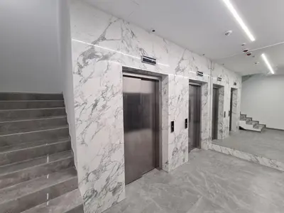 a hallway with stairs and a door in a building at GRAND LUX APARTMENTS in Banja Luka