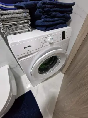 a washing machine with towels on top of it at Square Studio Tuzla in Tuzla