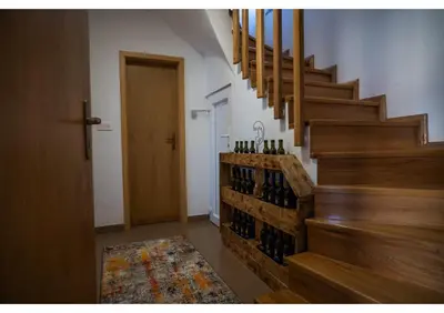 a hallway with a bunch of wine bottles on the wall at Holiday home Maša - Kupres in Kupres