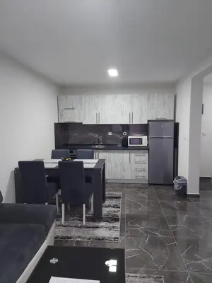 a kitchen with a table and chairs and a refrigerator at MALM Travnik in Travnik