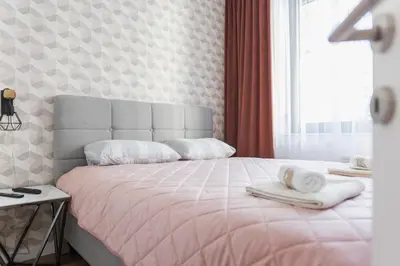 a bedroom with a bed with two towels on it at Comfort Lux Residence in Banja Luka