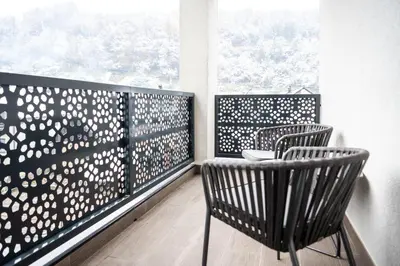 a balcony with two chairs and a window at Hotel Adriale in Kreševo