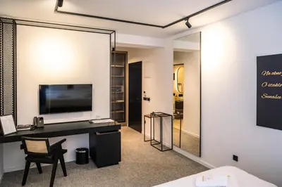 a room with a desk with a television and a mirror at Hotel Adriale in Kreševo