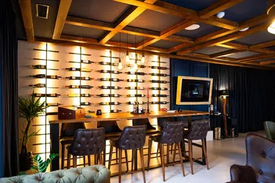 a bar with chairs and a table in a room at Hotel Adriale in Kreševo