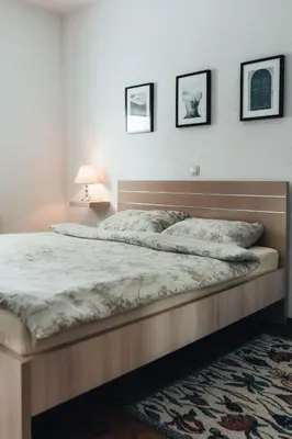 a bed in a bedroom with three pictures on the wall at Rosa Canina Kupres in Kupres