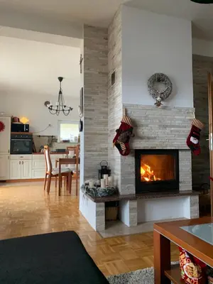 a living room with a fireplace and a dining room at Rosa Canina Kupres in Kupres