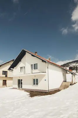 a white house with snow in front of it at Rosa Canina Kupres in Kupres