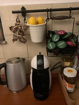 a coffee maker on a counter with a basket of fruit at Rosa Canina Kupres in Kupres