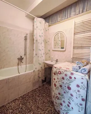 a bathroom with a tub and a sink and a bath tub at Heart of the City in Banja Luka