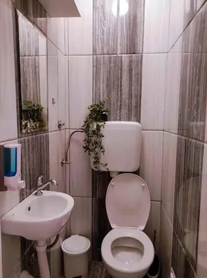 a bathroom with a toilet and a sink at Heart of the City in Banja Luka
