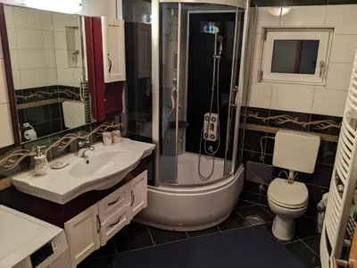 a bathroom with a shower and a sink and a toilet at Apartmani Hrastik 2 in Bihać