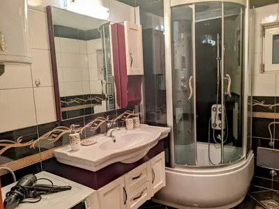 a bathroom with a sink and a shower at Apartmani Hrastik 2 in Bihać