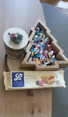a wooden box of chocolates and a bowl of cheese at Vlašićka ruža Eko FIS 303 in Vlasic