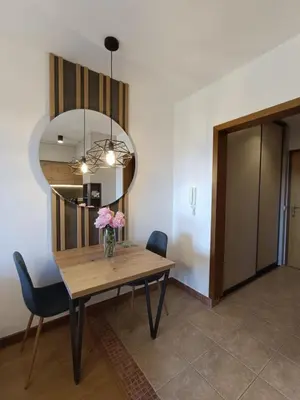 a dining room table with a vase of flowers on it at Vlašićka ruža Eko FIS 303 in Vlasic