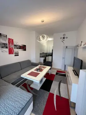 a living room with a couch and a table at Unas apartment in Bihać