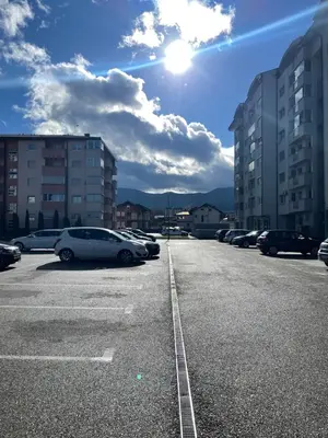 a parking lot with cars parked in it at Unas apartment in Bihać