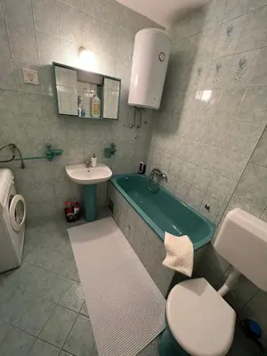 a bathroom with a tub and a toilet and a sink at Apartman Centar Travnik in Travnik