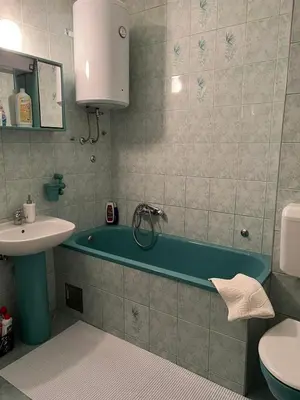 a bathroom with a tub and a sink and a toilet at Apartman Centar Travnik in Travnik