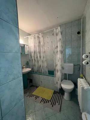 a bathroom with a toilet and a sink and a shower at Apartman Centar Travnik in Travnik