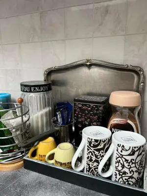 a shelf with coffee mugs and other items in a kitchen at Apartman Centar Travnik in Travnik