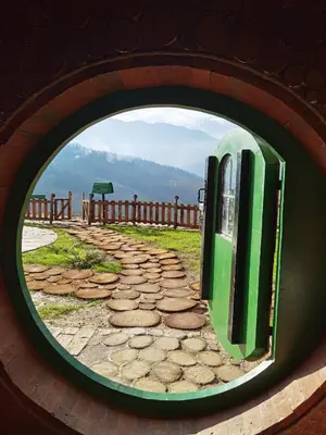 a circular view of a stone road with a green door at Zemljane kućice Kreševo in Kreševo