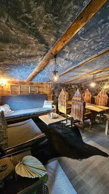 a bedroom with a bed and a table and chairs at Zemljane kućice Kreševo in Kreševo