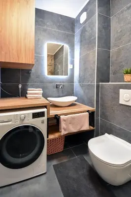 a bathroom with a washing machine and a toilet at Apartman Filip in Banja Luka