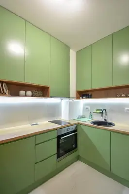 a kitchen with green cabinets and a sink at Apartman Filip in Banja Luka