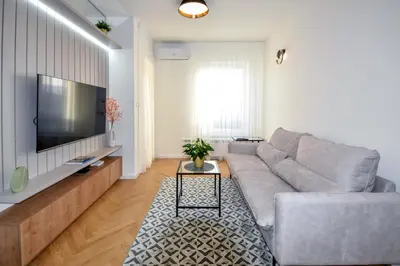 a living room with a couch and a flat screen tv at Apartman Filip in Banja Luka