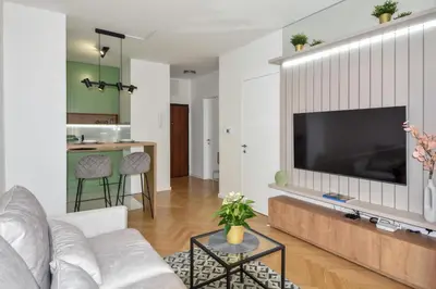 a living room with a large television on a wall at Apartman Filip in Banja Luka