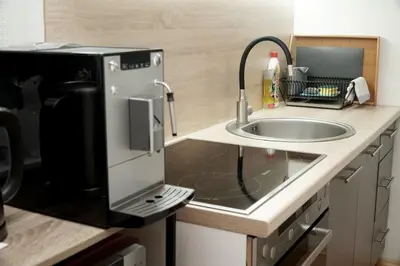 a kitchen with a sink and a microwave at Planinska kuca NATURA in Vlasic
