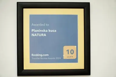 a framed picture of a framed picture of a framed certificate at Planinska kuca NATURA in Vlasic