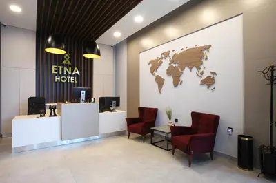 a lobby with a map of the world on the wall at Hotel ETNA in Gračanica