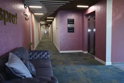 a hallway with a couch in the middle of a building at Hotel ETNA in Gračanica
