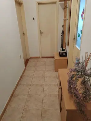a hallway with a tile floor and a door at Apartman Leko in Kupres